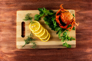 crab with lemon and parsley on a cutting Board