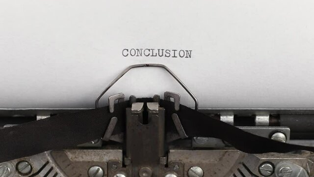 to type a quote conclusion on a vintage and old typewriter close-up