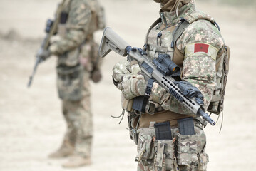 Soldiers with assault rifle and flag of Morocco on military uniform. Collage.