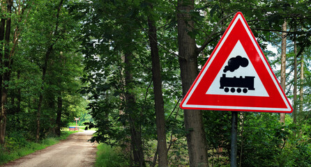 Unpaved road with unguarded railroad crossing in a forest near Winterswijk, Netherlands