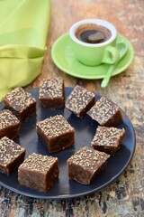 Dates tahini square sweet bites topped with sesame seeds. Served with espresso coffee.
