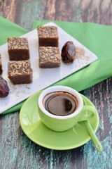 Dates tahini square sweet bites topped with sesame seeds. Served with espresso coffee.
