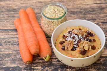 Carrot oat porridge with raisin, walnut and coconut flakes