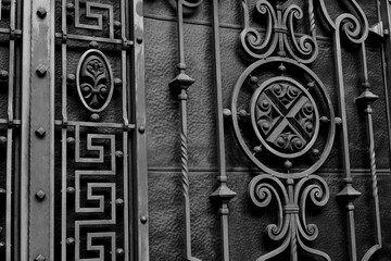 Decorative forged metal gates elements. Forged metal ornaments. Wrought iron gates. Ornamental forging, forged elements close up.