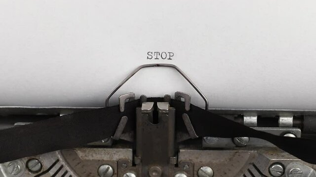 to type a quote stop on a vintage and old typewriter close-up
