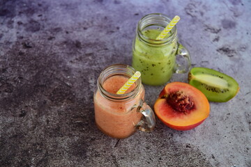 Fresh peach and kiwi juice in jars