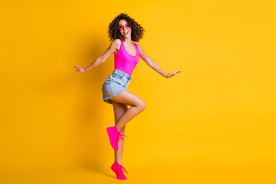 Full length body size view of her she nice-looking attractive lovely cheerful wavy-haired girl jumping having fun dancing disco party isolated on bright vivid shine vibrant yellow color background