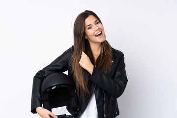 Young woman with a motorcycle helmet over isolated white background celebrating a victory