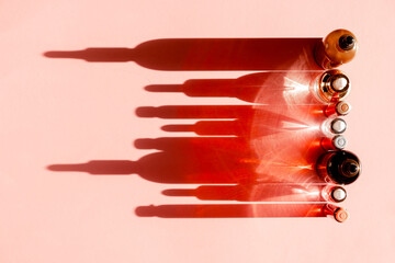 Glass Bottles with fluid collagen and hyaluronic acid, hydration skin. Top flatlay view copyspace. Natural background with hard light