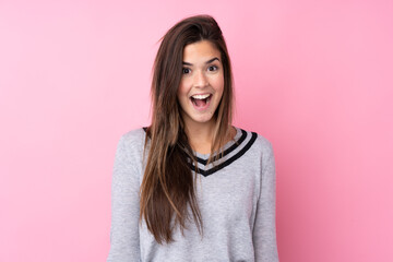 Fototapeta premium Teenager girl over isolated pink background with surprise facial expression