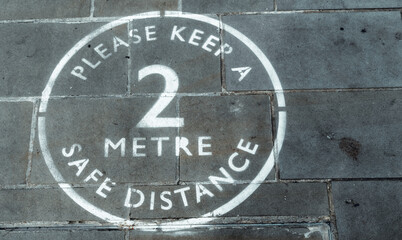 Two Metre social distancing painted sign in a high street