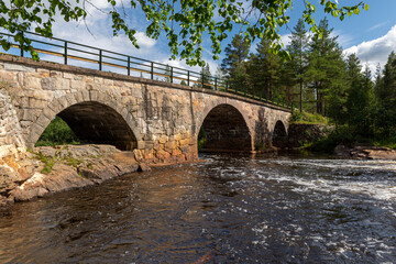 Stone bridge over a little river in northern Sweden