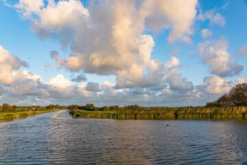Just after sunrise the sun shines beautifully on the clouds above the Meerpolder near lake Zoetermeerse Plas