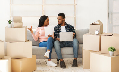 Upset black couple with laptop having problem with property documents, filing online complaint to...