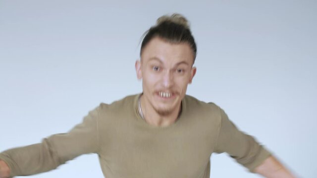 An aggressive man threatens to attack. Guy in a rage. Furious hipster.