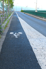 Obraz premium Cycle path dedicated to cycling, lane reserved for users of non-motorized means of transport. Road marking. 