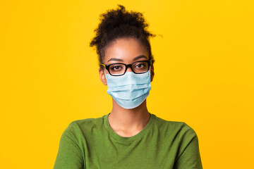 Portrait of black woman wearing medical mask and glasses