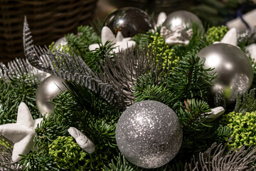 Christmas floral arrangement with spruce branches and silver ornaments. 