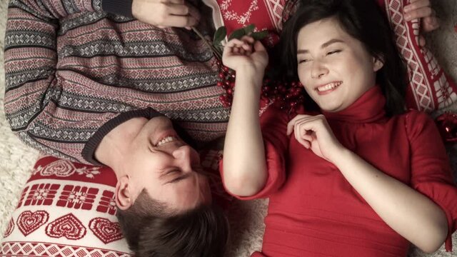 Happy couple in love enjoying xmas and lying head to head. Top view. Relationship, family, christmas, new year, holiday concet.