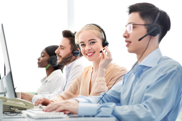 Telemarketing concept. Happy hotline operators selling goods or services through VoIP telephony at call centre