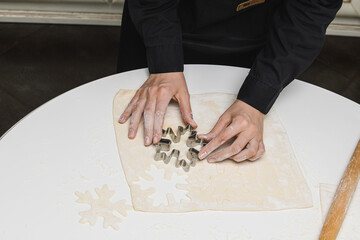 cook the chef rolls the dough for the cookies.