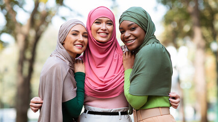 Three Muslim Women In Hijab Posing Hugging Outdoors, Panorama