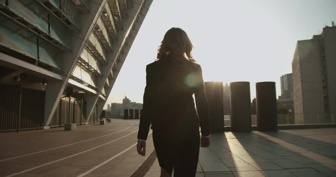 Confident woman in business suit walking forward, motivated to achieve goal