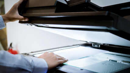 Business man Hand press button on panel of printer, printer scanner laser office copy machine...