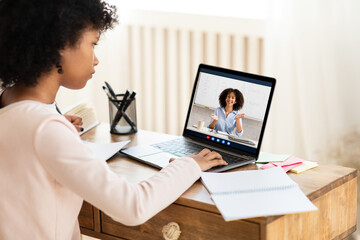 African Schoolgirl At Laptop Having Online Lesson With Teacher Indoors