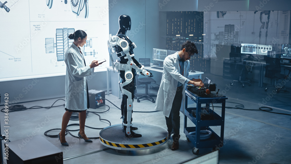 Aufkleber in robotics development laboratory: chief female engineer and top male scientist work on a bionics e