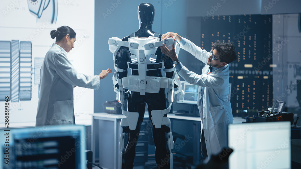 Poster chief analyst uses computer, female engineer and top male scientist work on a bionics exoskeleton pr