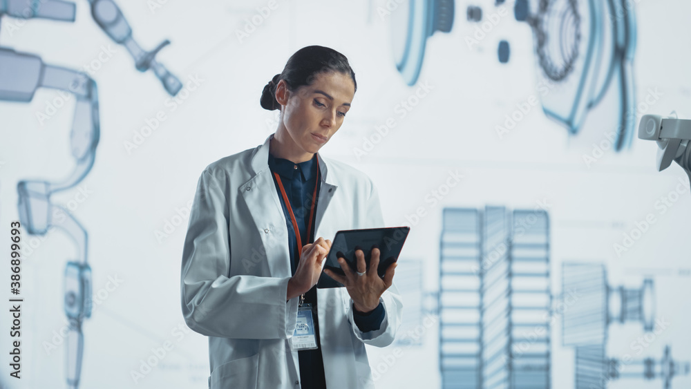 Poster in development laboratory: portrait of beautiful chief female engineer wearing white coat using digi