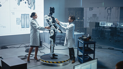 In Robotics Development Laboratory: Chief Female Engineer and Top Male Scientist Work on a Bionics...