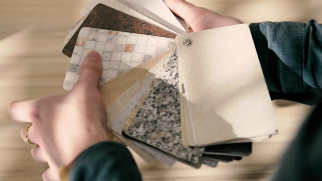 catalog of textures for kitchen countertops in the hands of architect designer sales consultant