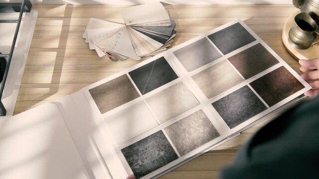 catalog of textures for kitchen countertops in the hands of architect designer sales consultant