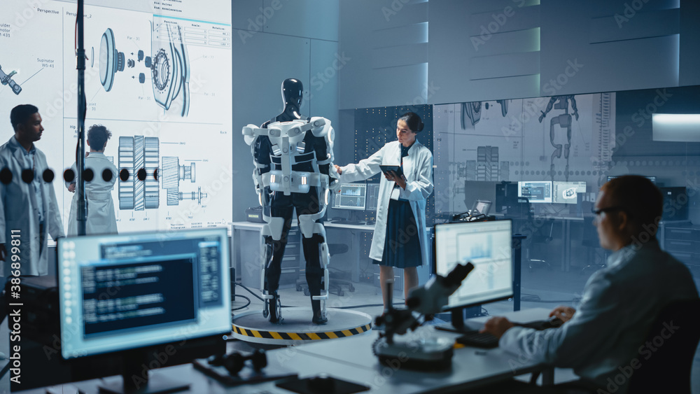 Leinwandbilder in robotics development laboratory: female scientist uses digital tablet computer, work on a robotic