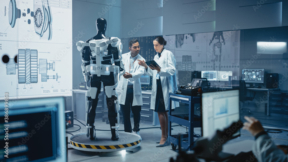 Poster In Robotics Development Laboratory: Chief Female Engineer and Top Male Scientist Work on a Bionics Exoskeleton Prototype. Designing Powered Exosuit to Help Disabled People, Hard Labor Workers