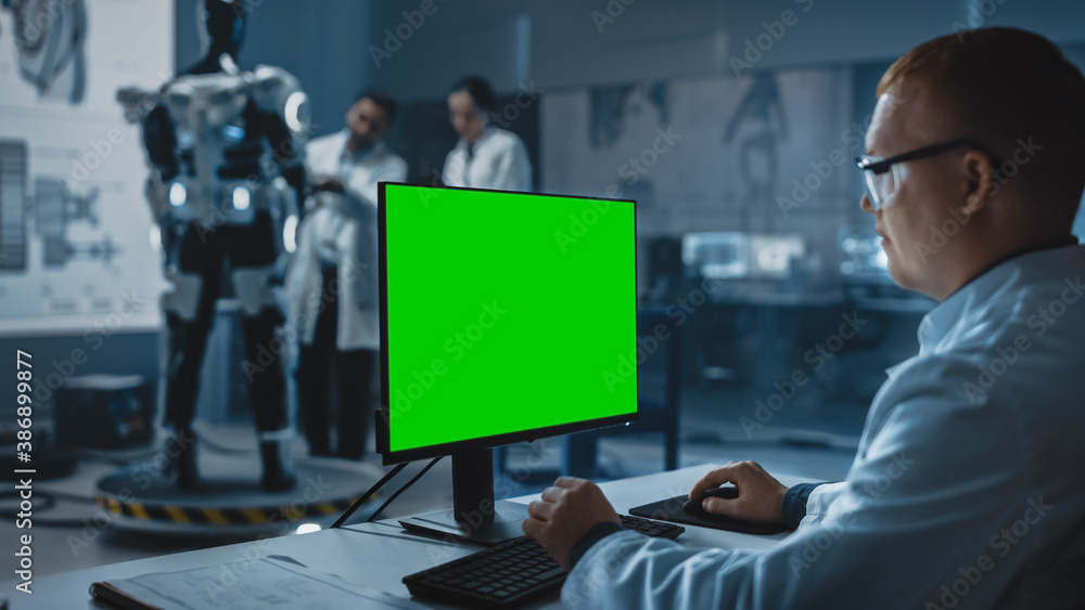 Poster in development laboratory: chief analyst uses computer with green screen template, scientists and en