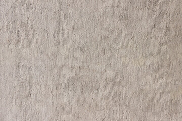 Rough uneven surface of the plastered wall.