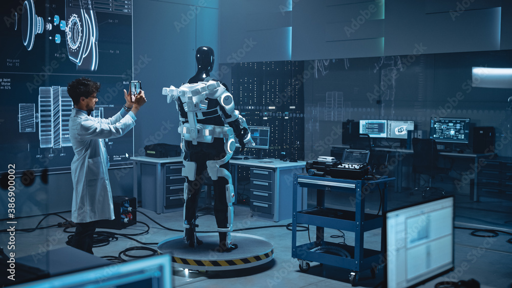 Leinwandbilder In Robotics Development Laboratory: Engineer Uses Digital Tablet Computer with Augmented Reality to Design Exoskeleton Prototype. Building Exosuit to Help Disabled People Walk, Workers Lift Goods 
