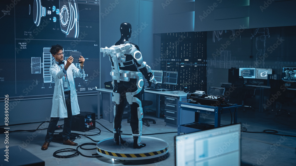 Leinwandbilder In Robotics Development Laboratory: Engineer Uses Digital Tablet Computer with Augmented Reality to Design Exoskeleton Prototype. Building Exosuit to Help Disabled People Walk, Workers Lift Goods 