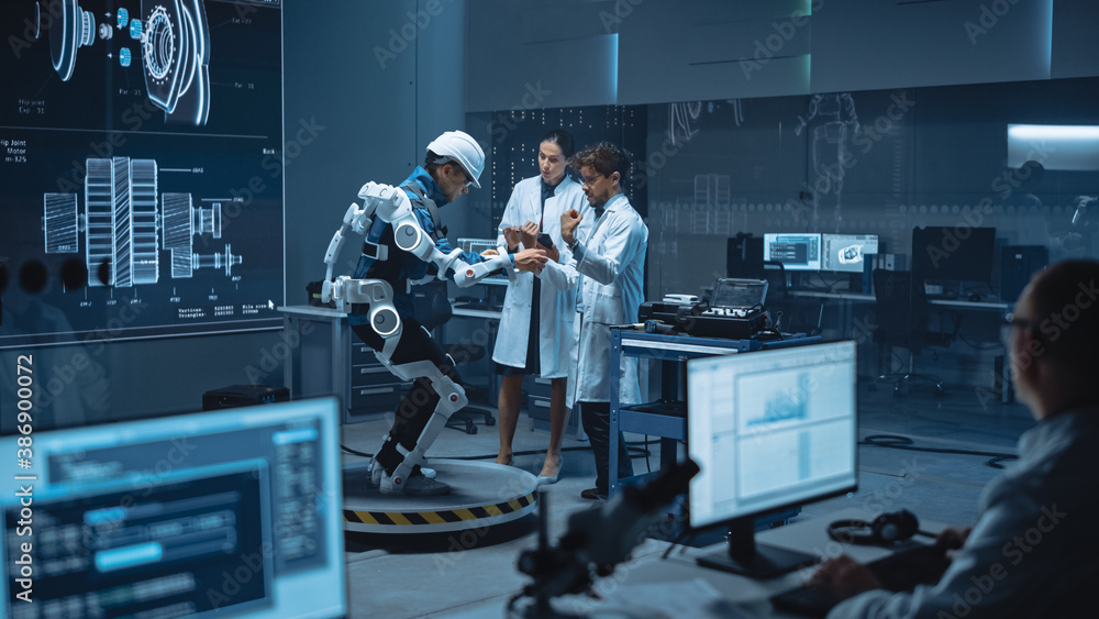 Leinwandbilder In Robotics Development Laboratory: Engineers and Scientists Work on a Bionics Exoskeleton Prototype with Person Testing it. Designing Wearable Exosuit to Help Disabled People, Warehouse Workers