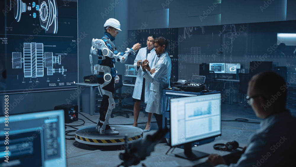 Leinwandbilder In Robotics Development Laboratory: Engineers and Scientists Work on a Bionics Exoskeleton Prototype with Person Testing it. Designing Wearable Exosuit to Help Disabled People, Warehouse Workers