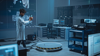 In High-Tech Development Laboratory: Engineer Uses Digital Tablet Computer with Augmented Reality...