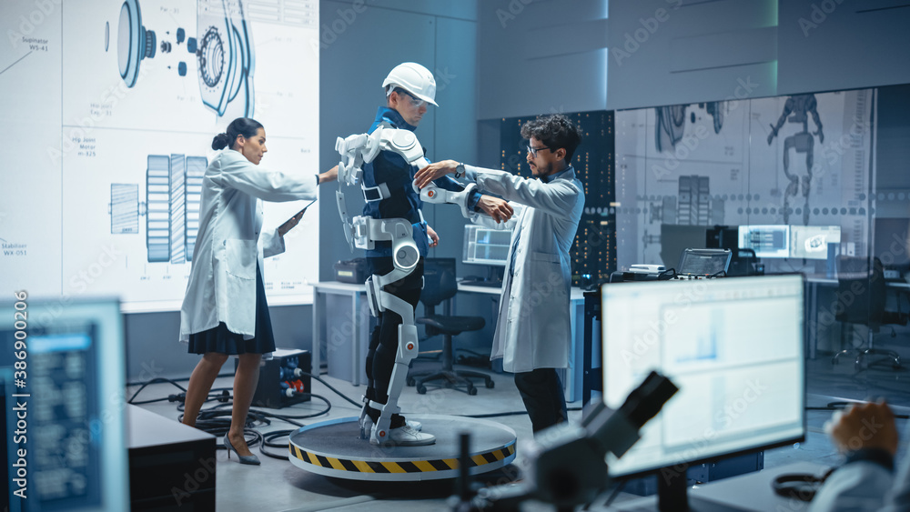 Leinwandbilder In Robotics Development Laboratory: Engineers and Scientists Work on a Bionics Exoskeleton Prototype with Person Testing it. Designing Wearable Exosuit to Help Disabled People, Warehouse Workers