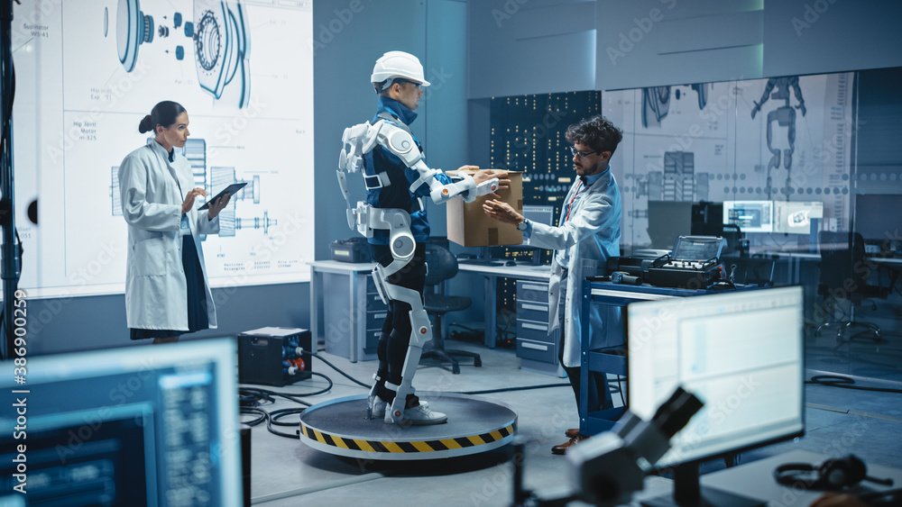 Leinwandbilder in development laboratory: engineers work on a robotic exoskeleton with a person testing it by tryin