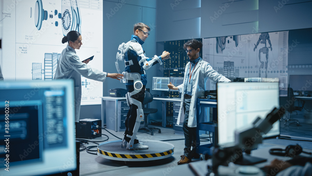Leinwandbilder In Robotics Development Laboratory: Engineers and Scientists Work on a Bionics Exoskeleton Prototype with Person Testing it. Designing Wearable Exosuit to Help Disabled People, Warehouse Workers