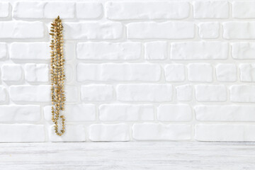 Dried okra hanging on white brick wall textured background 
