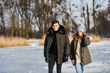 happy couple hugging and laughing outdoors in winter