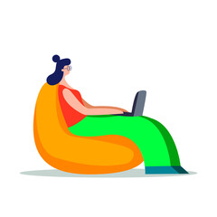 Girl sitting on a cushion chair and working at a computer. Freelance work concept